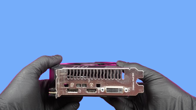 Computer repair in St Andrews - technician holding a GPU graphics card for diagnosis